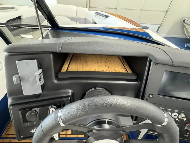 Slide: The Image of 2025 Moomba Mojo boat dashboard with steering wheel and control panel. - 22