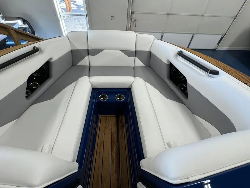Slide: The Image of 2025 Moomba Mojo boat interior with white seating and cup holders. - 25