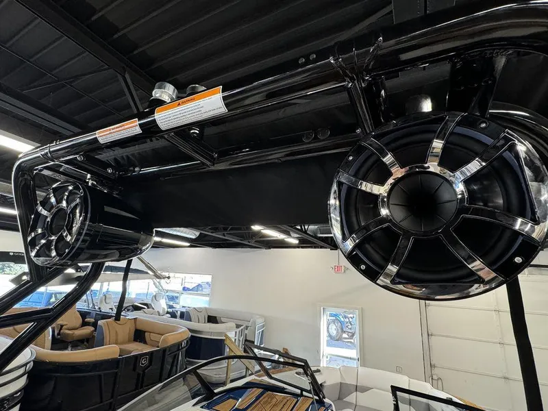 Slide: The Image of 2025 Moomba Mojo boat speakers and interior in showroom setting. - 27