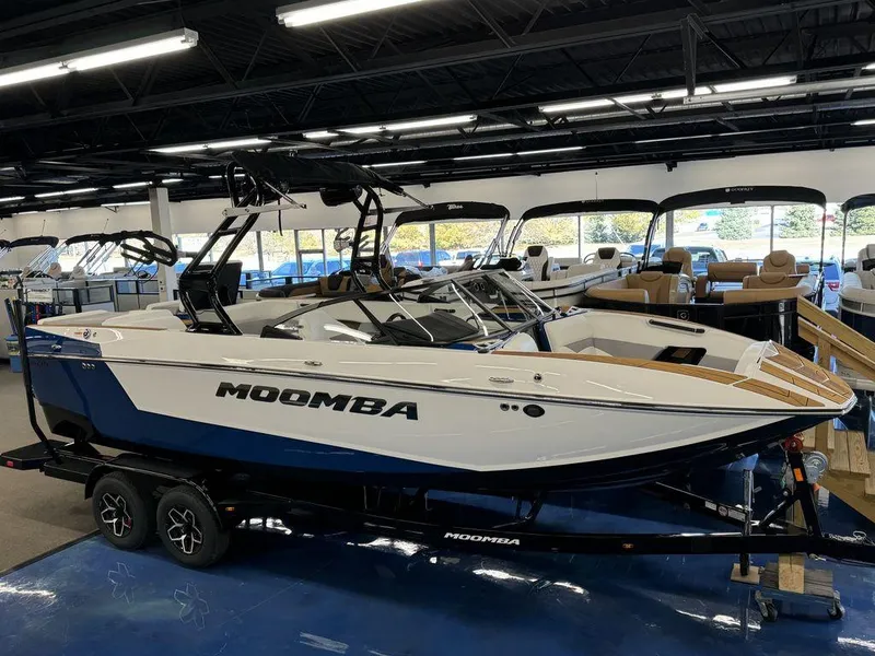 Slide: The Image of 2025 Moomba Mojo boat displayed in showroom, featuring sleek design and modern features. - 3