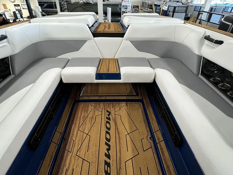 Slide: The Image of 2025 Moomba Mojo boat interior with white seating and wood-style flooring. - 5