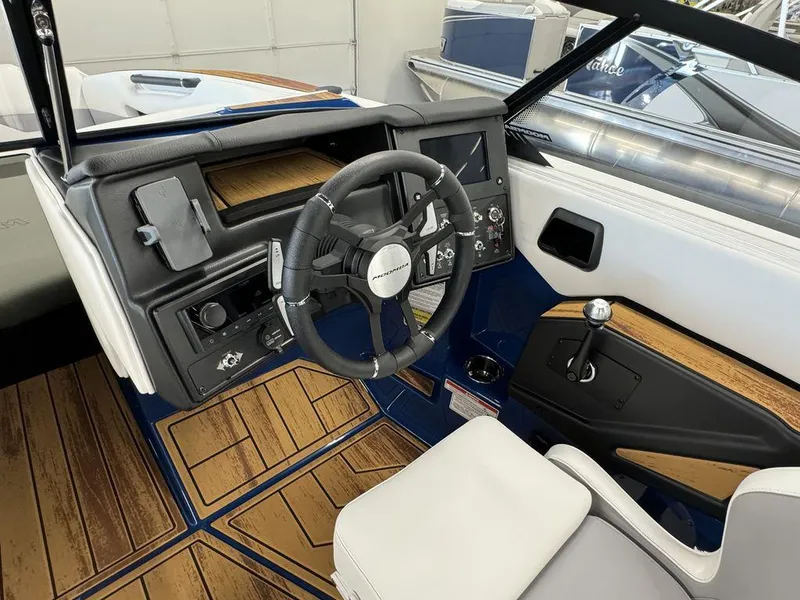 Slide: The Image of 2025 Moomba Mojo boat interior with modern steering wheel and wood accents. - 6