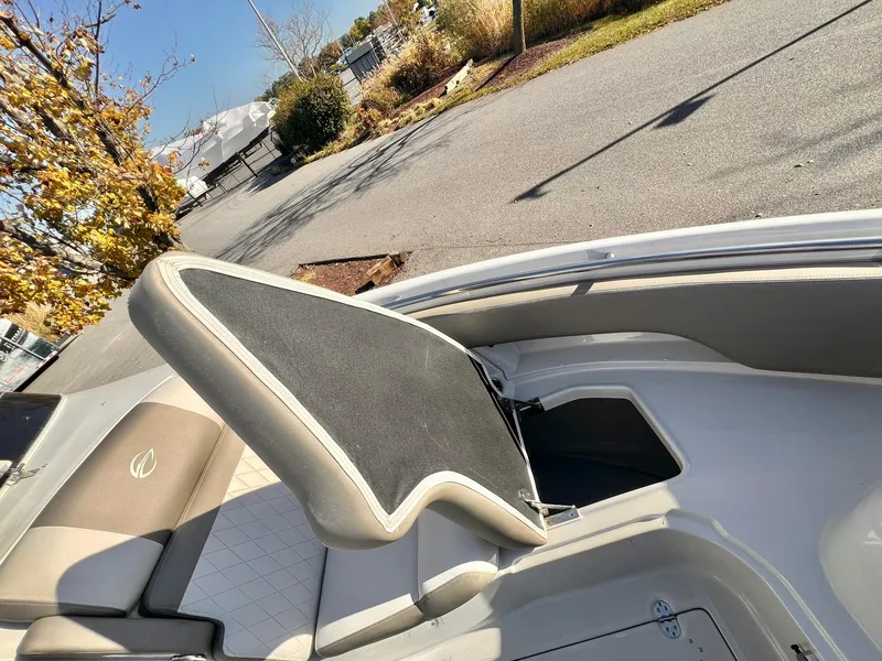 Slide: The Image of Crownline 280 DC 2025 boat interior with open storage compartment. - 11