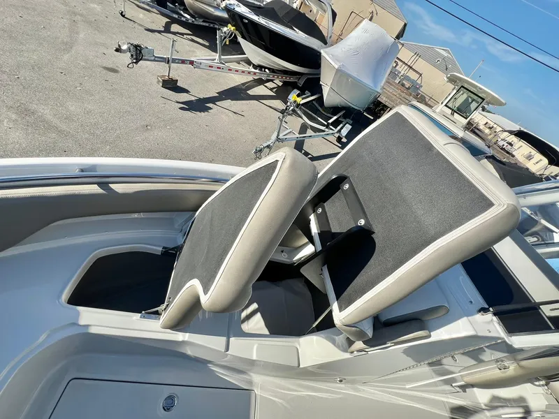 Slide: The Image of 2025 Crownline 280 DC boat interior with adjustable seating and storage compartment. - 12