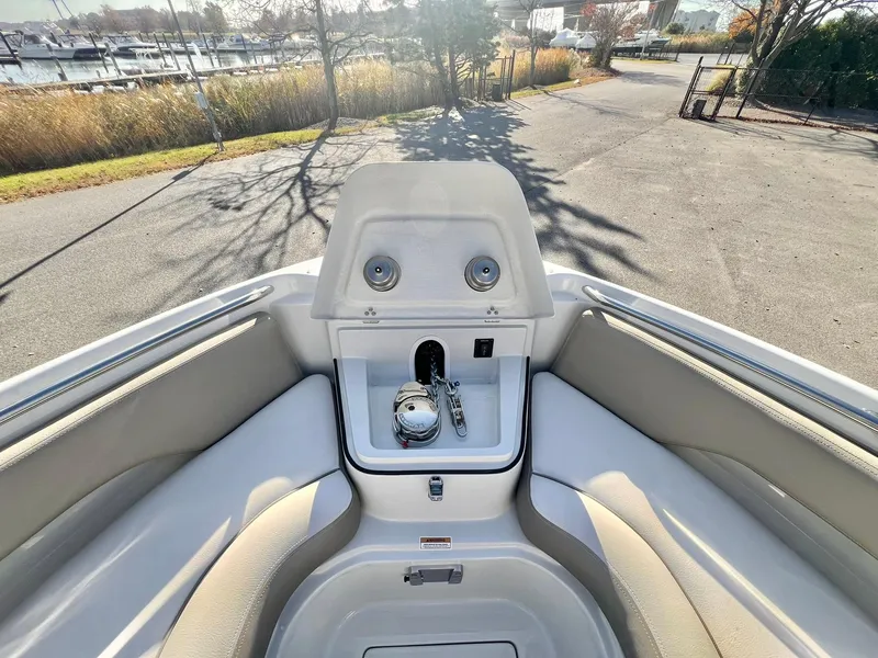 Slide: The Image of 2025 Crownline 280 DC boat interior with seating and storage compartment. - 17