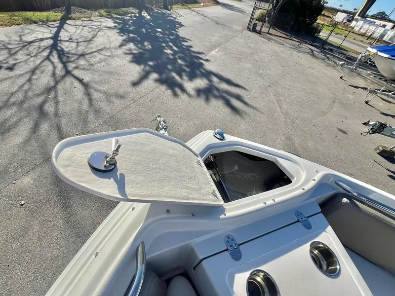 Slide: The Image of Crownline 280 DC 2025 boat with open storage compartment on deck. - 20