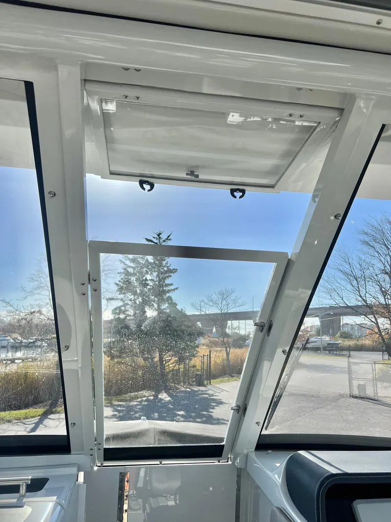 Slide: The Image of Interior view of 2025 Crownline 280 DC boat with open hatch and clear sky. - 23