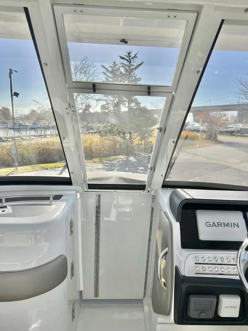 Slide: The Image of Interior view of 2025 Crownline 280 DC boat cockpit with Garmin navigation system. - 24