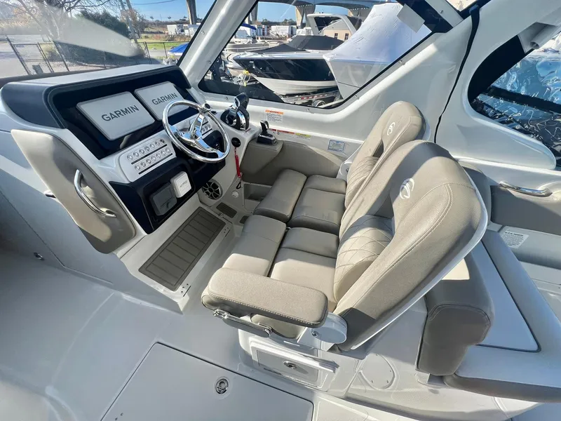 Slide: The Image of Interior of 2025 Crownline 280 DC boat with Garmin navigation system and plush seating. - 29
