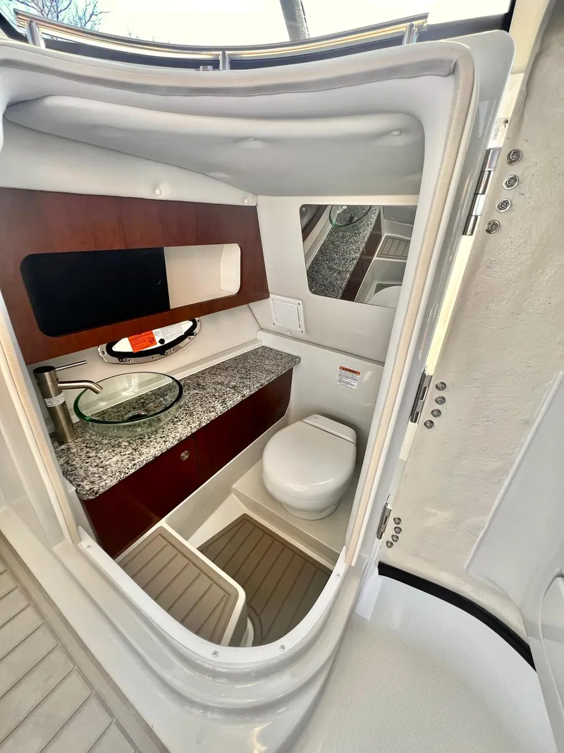 Slide: The Image of 2025 Crownline 280 DC boat interior bathroom with modern fixtures and sleek design. - 3