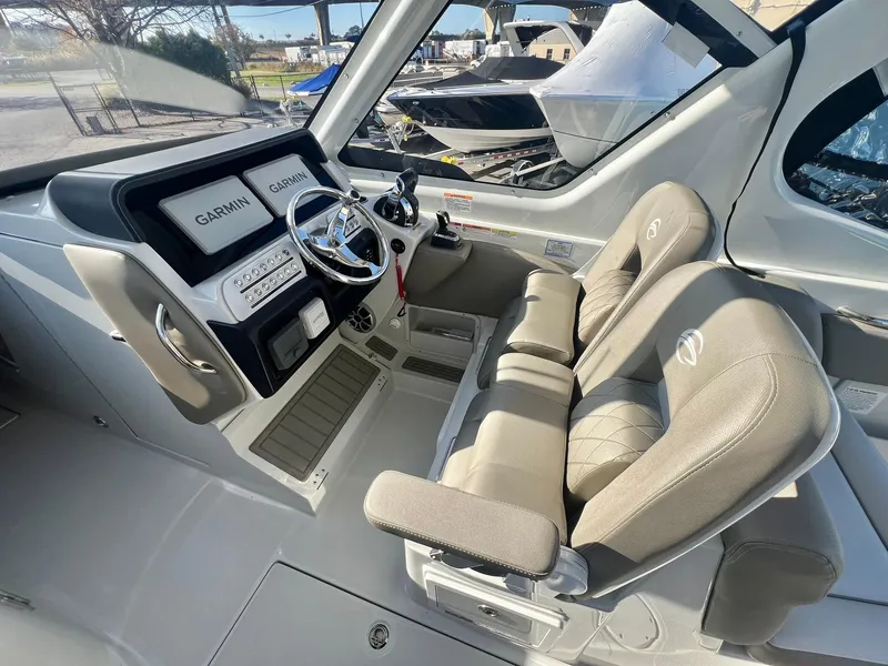Slide: The Image of Crownline 280 DC 2025 boat interior with Garmin navigation system and dual seating. - 30