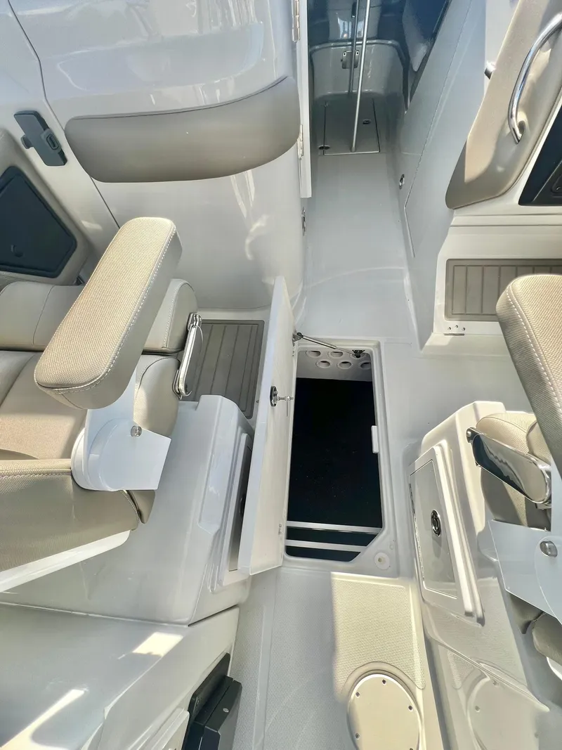 Slide: The Image of 2025 Crownline 280 DC boat interior with seating and storage compartments. - 33