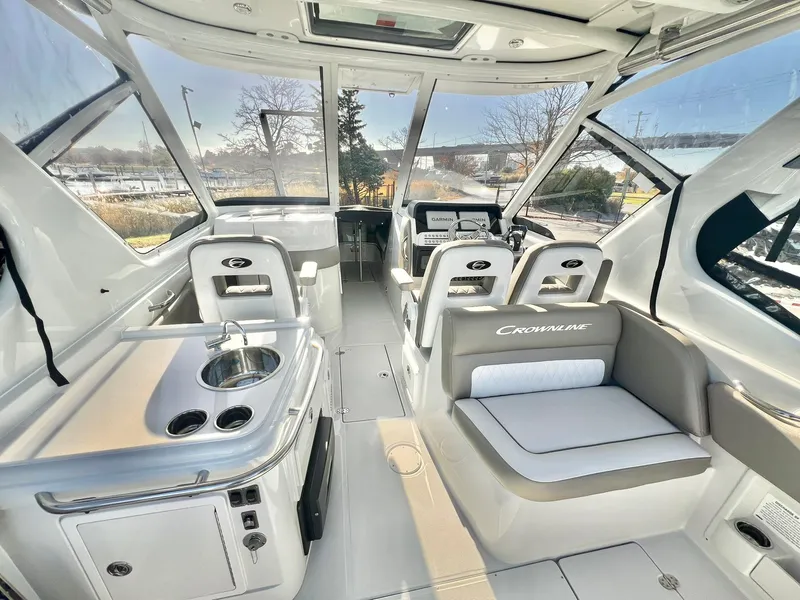 Slide: The Image of Luxurious 2025 Crownline 280 DC boat interior with seating and kitchenette. - 38