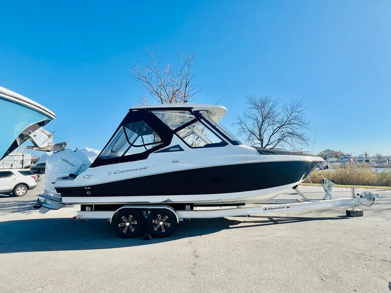 Slide: The Image of 2025 Crownline 280 DC boat on trailer under clear blue sky. - 4