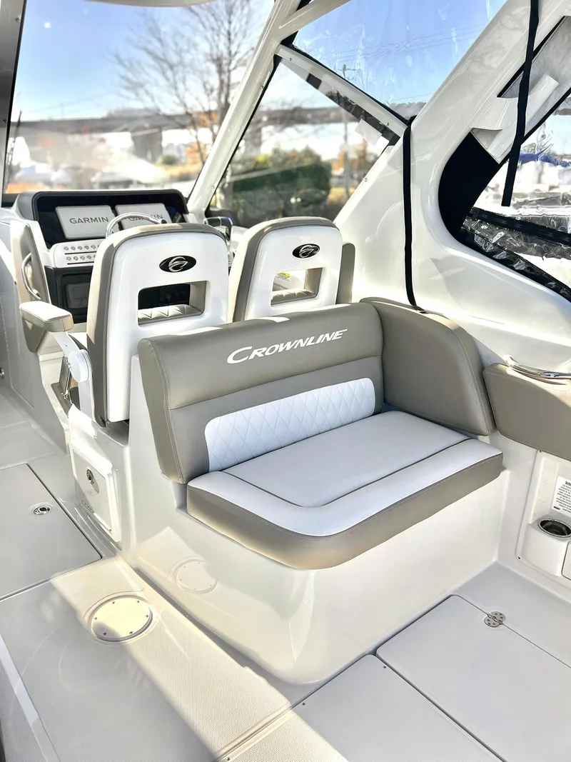 Slide: The Image of 2025 Crownline 280 DC boat interior with plush seating and modern design. - 40