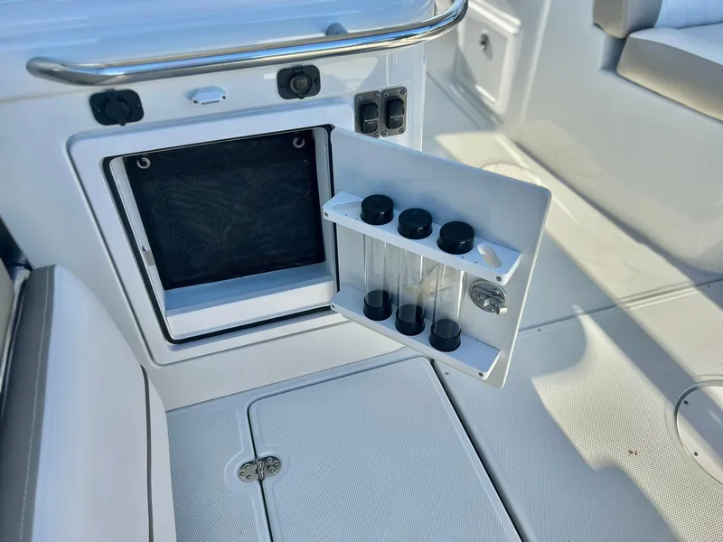 Slide: The Image of Crownline 280 DC 2025 boat interior with storage compartment and test tubes. - 41