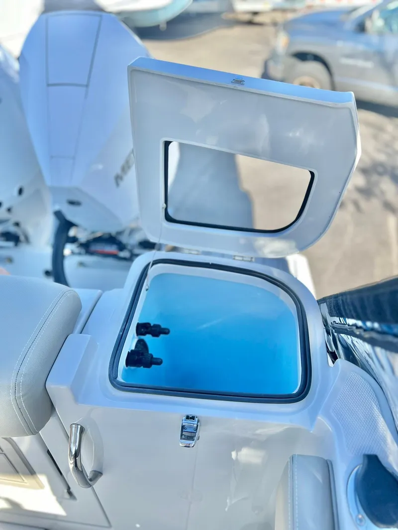 Slide: The Image of 2025 Crownline 280 DC boat with open storage compartment. - 42