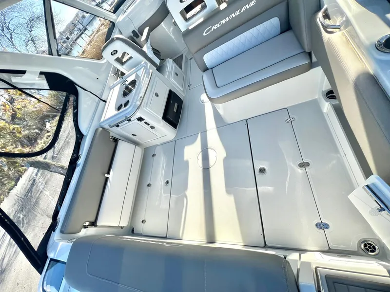 Slide: The Image of 2025 Crownline 280 DC boat interior with sleek seating and modern helm design. - 46