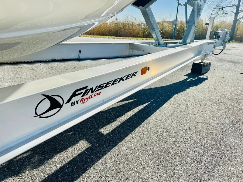 Slide: The Image of Trailer for 2025 Crownline 280 DC boat, featuring Finseeker by Redline branding. - 49
