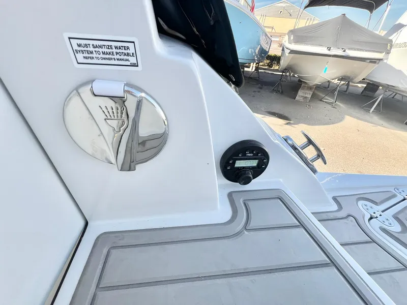 Slide: The Image of Crownline 280 DC 2025 boat deck with water system sanitization notice. - 6