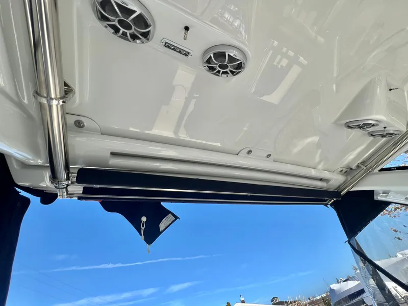 Slide: The Image of Crownline 280 DC 2025 boat interior with speakers and blue sky background. - 8