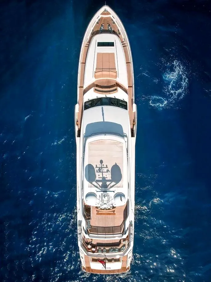 Slide: The Image of A serene mountain landscape at sunrise, with soft golden light casting over snow-capped peaks, a calm reflective lake in the foreground, and lush green trees surrounding the scene. The sky is a blend of orange, pink, and blue hues, adding warmth and tranq - 0