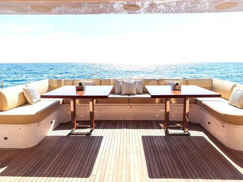 Slide: The Image of Luxury yacht deck with seating, tables, and ocean view; 33rd Strike Group model1123, 2026. - 8