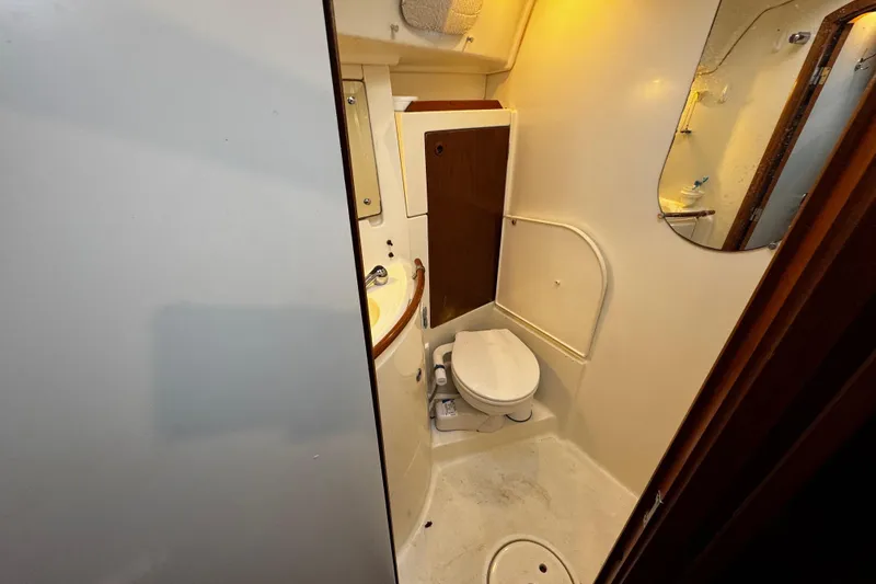 Slide: The Image of Bathroom interior of 1999 Beneteau Oceanis Clipper 461 yacht, featuring toilet and sink. - 104