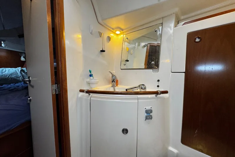 Slide: The Image of Bathroom interior of 1999 Beneteau Oceanis Clipper 461 yacht, featuring sink and mirror. - 106