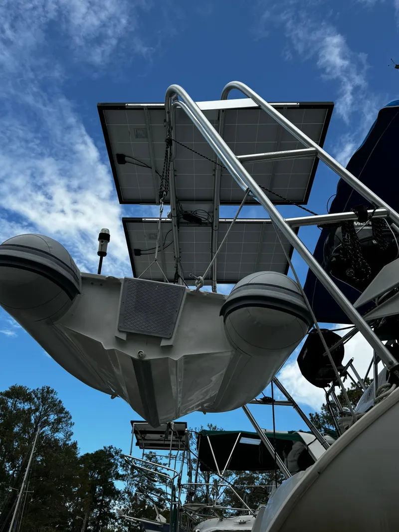 Slide: The Image of Galley of 1999 Beneteau Oceanis Clipper 461 with open fridge, window, and kitchen essentials. - 65
