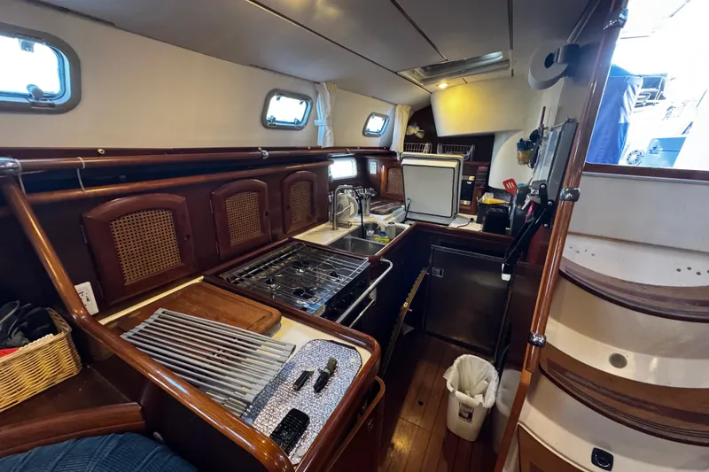 Slide: The Image of Interior of 1999 Beneteau Oceanis Clipper 461 yacht kitchen with wooden cabinetry and appliances. - 76