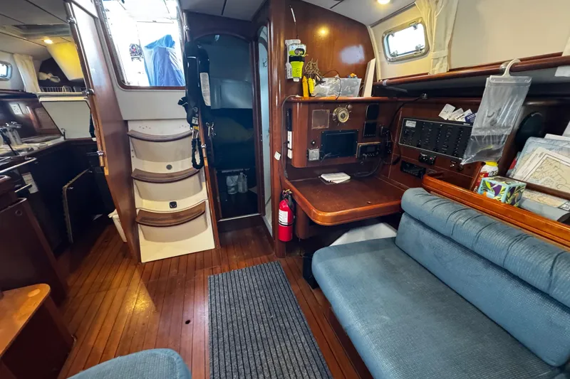 Slide: The Image of Interior of 1999 Beneteau Oceanis Clipper 461 yacht, featuring navigation station and seating area. - 93