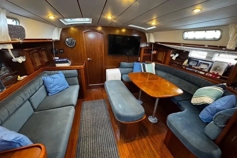 Slide: The Image of Interior of 1999 Beneteau Oceanis Clipper 461 yacht with cozy seating and wooden finishes. - 95