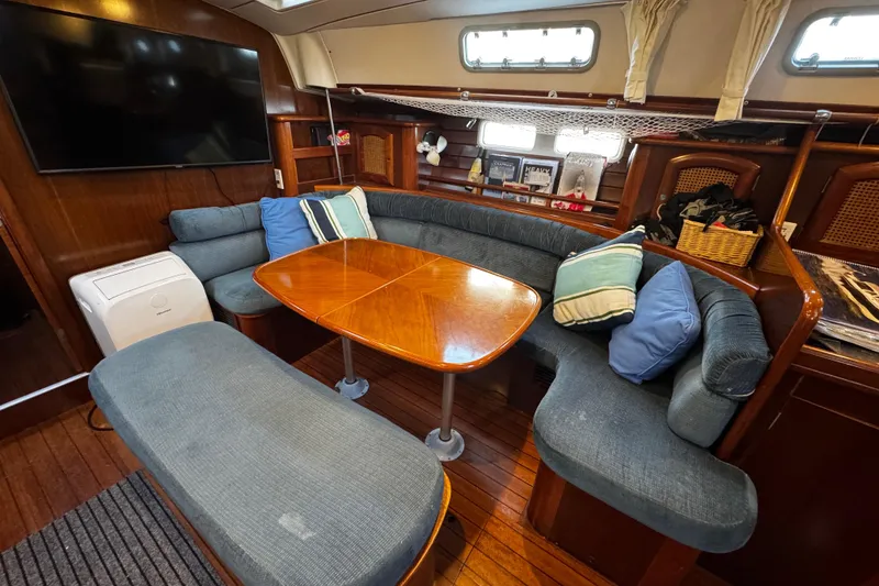 Slide: The Image of salon dinette, comfortably seats at least 8 for gatherings. under the bench seat is ample storage - 96