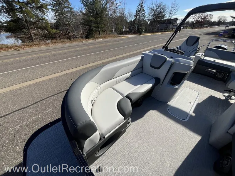 Slide: The Image of 2024 Avalon LSZ Versatile Rear Bench boat with sleek seating on a sunny day. - 12