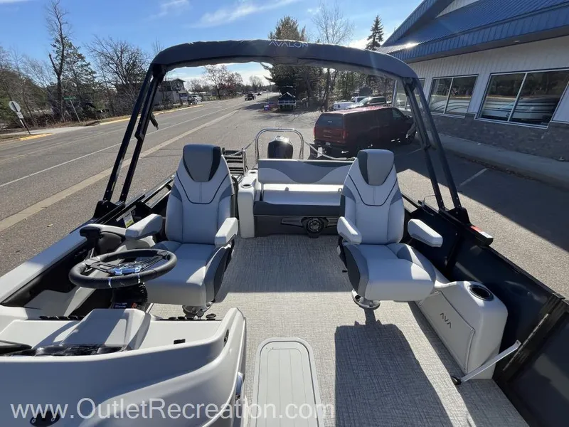 Slide: The Image of 2024 Avalon LSZ Versatile Rear Bench boat interior with modern seating and steering wheel. - 14
