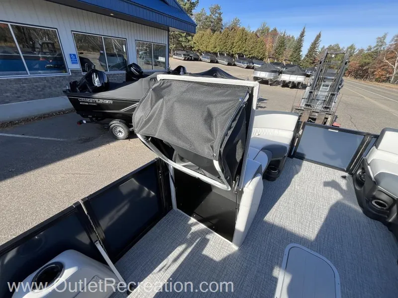 Slide: The Image of 2024 Avalon LSZ Versatile Rear Bench pontoon boat with open seating area. - 23