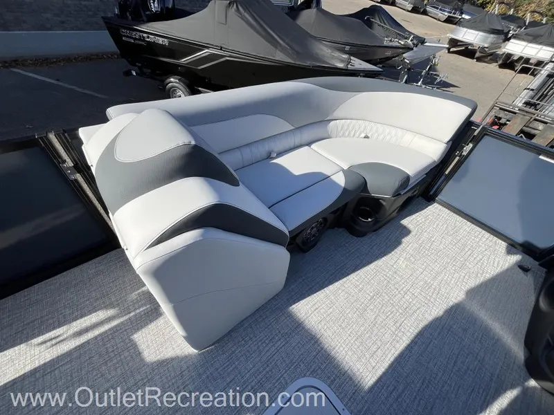 Slide: The Image of 2024 Avalon LSZ Versatile Rear Bench boat seating, gray upholstery, outdoor setting. - 25