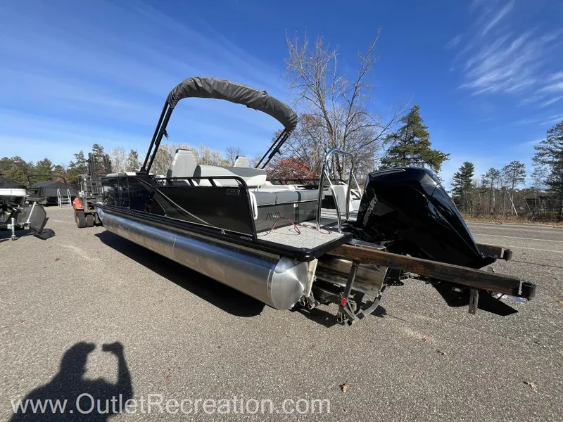 Slide: The Image of 2024 Avalon LSZ Versatile Rear Bench pontoon boat in outdoor setting. - 6
