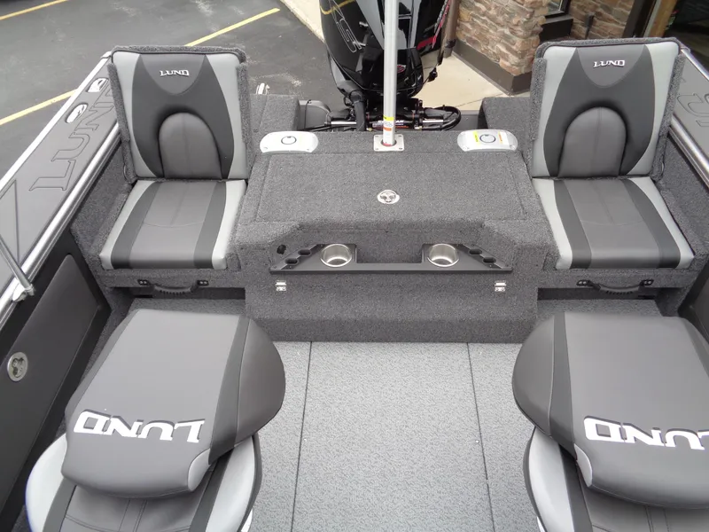 Slide: The Image of 2025 Lund 1975 Pro-V boat interior with gray seating and storage compartments. - 19