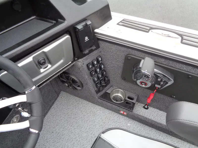 Slide: The Image of Interior of 2025 Lund 1975 Pro-V boat, featuring control panel and steering wheel. - 27