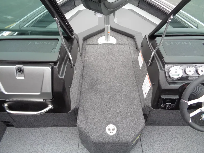 Slide: The Image of Interior view of 2025 Lund 1975 Pro-V boat, featuring dashboard and seating area. - 28