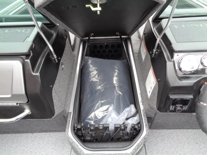 Slide: The Image of 2025 Lund 1975 Pro-V boat storage compartment with protective cover. - 29