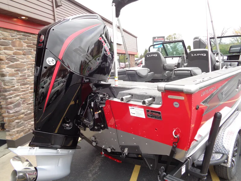 Slide: The Image of 2025 Lund 1975 Pro-V boat with powerful outboard motor, red and black design. - 42