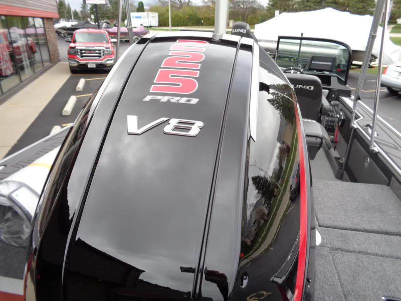 Slide: The Image of 2025 Lund 1975 Pro-V boat with V8 engine, sleek black design. - 46