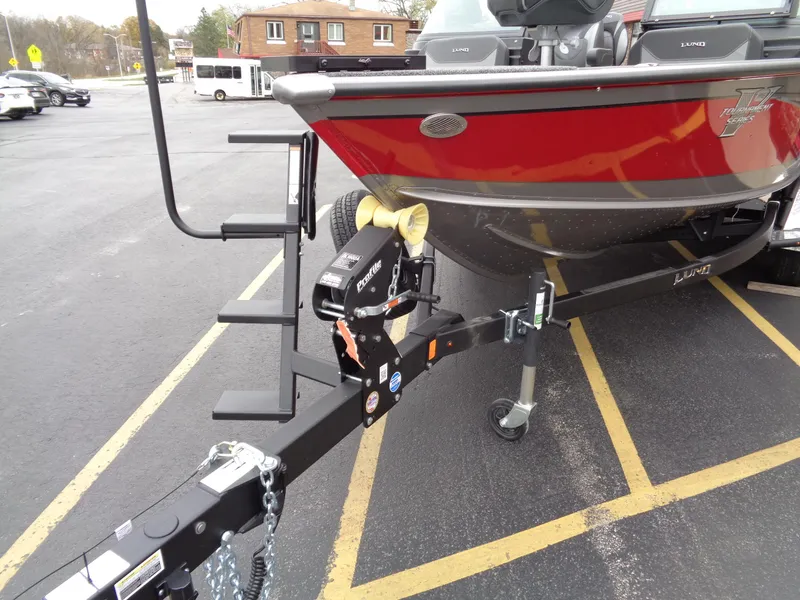 Slide: The Image of 2025 Lund 1975 Pro-V boat on trailer in parking lot. - 9