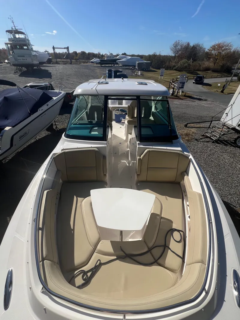 Slide: The Image of 2017 Pursuit 325 DC Dual Console boat with spacious seating and sleek design. - 18