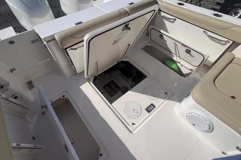 Slide: The Image of 2017 Pursuit 325 DC Dual Console boat interior with open storage compartments. - 21