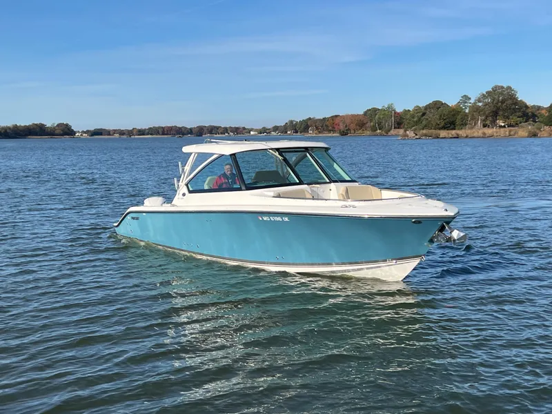 Slide: The Image of 2017 Pursuit 325 DC Dual Console boat on calm water. - 3