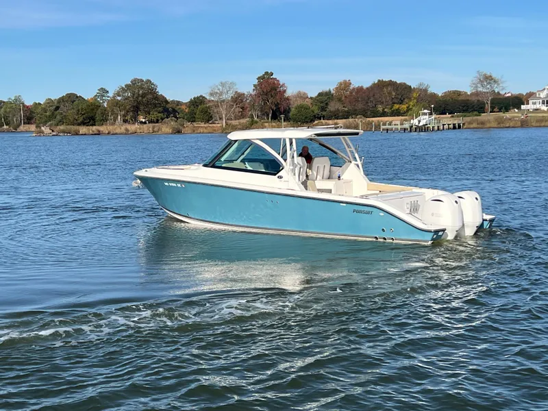 Slide: The Image of 2017 Pursuit 325 DC Dual Console boat cruising on a calm lake. - 30